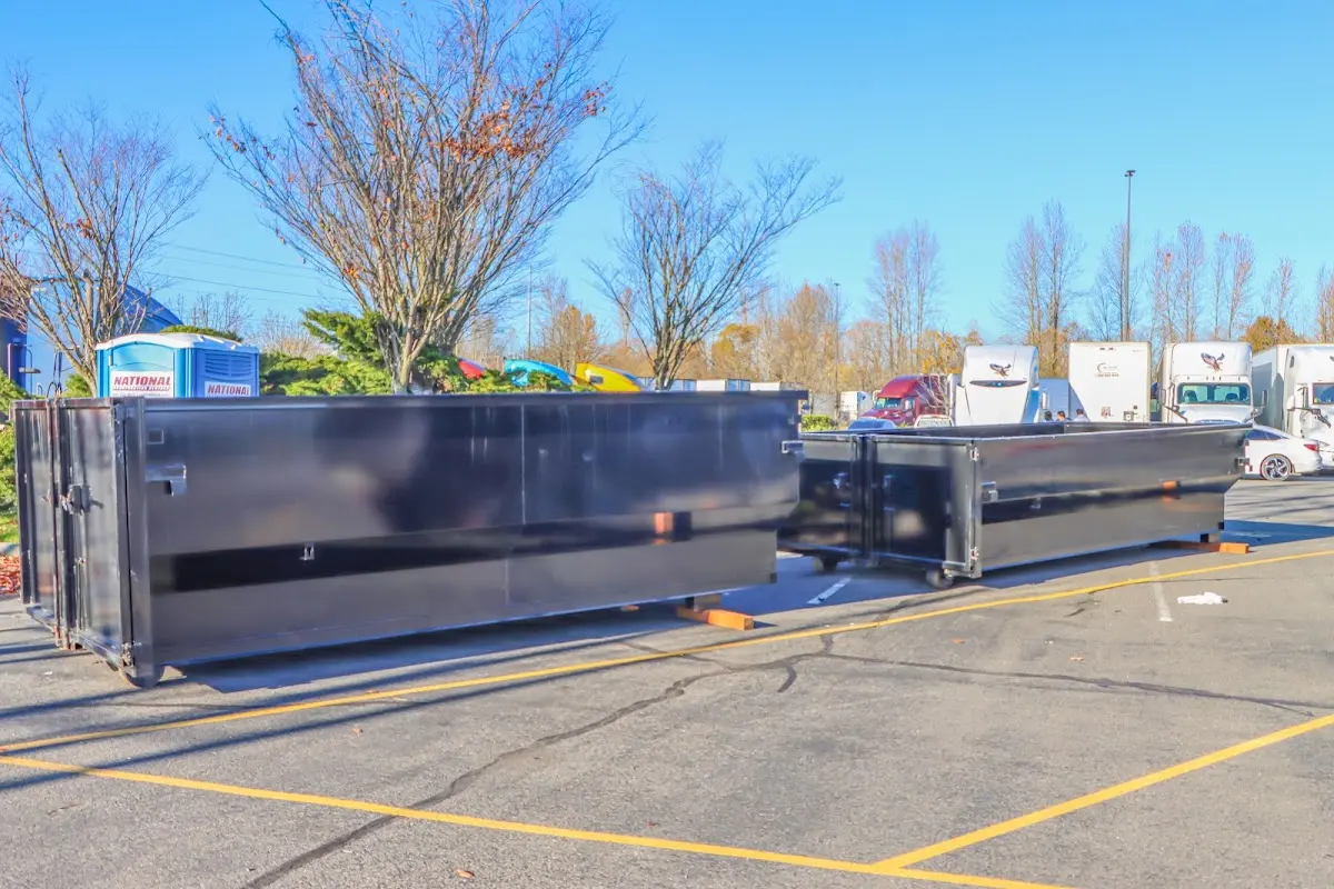 Professional dumpster rental service with roll-off container on residential driveway in Beacon